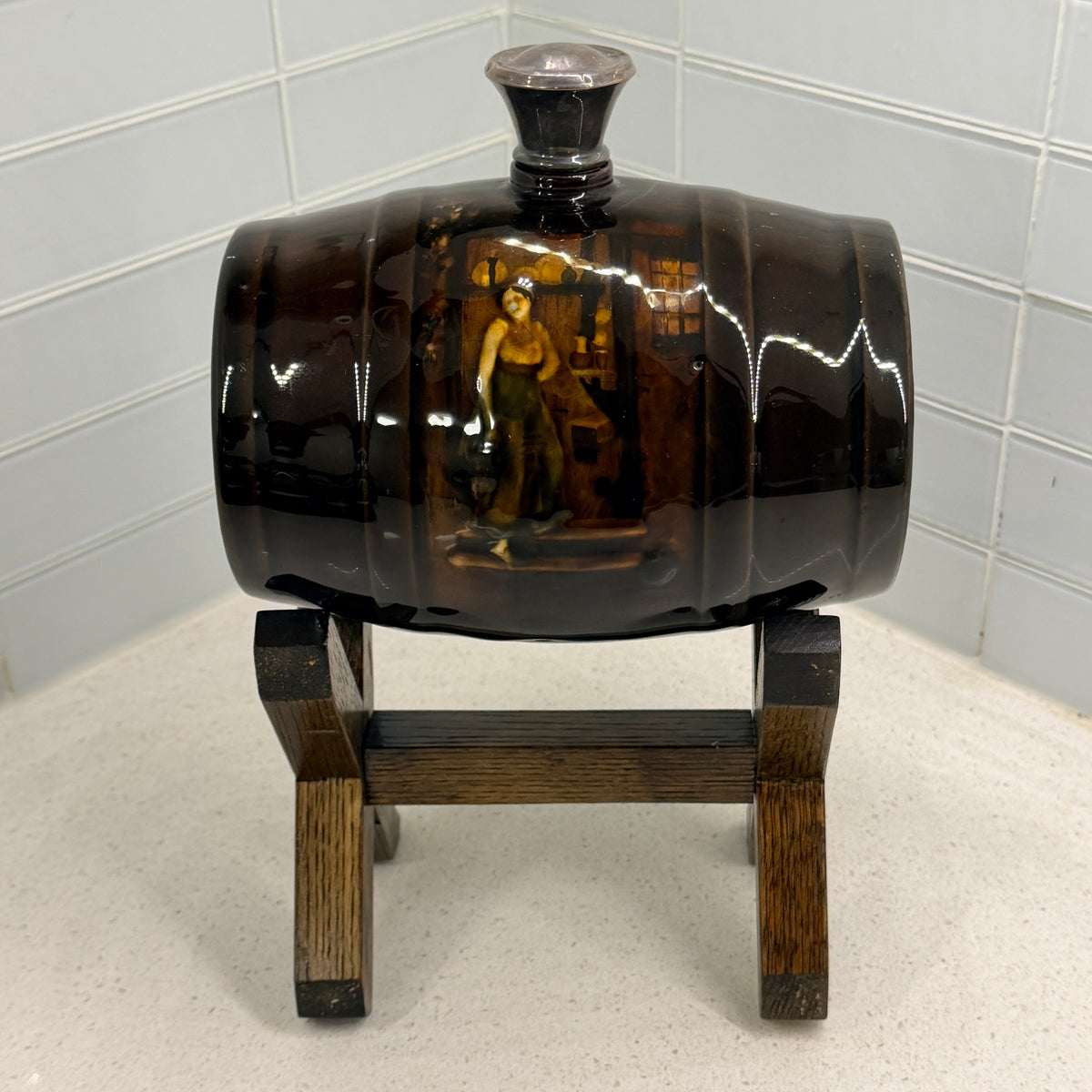 Royal Doulton Kingsware spirit barrel on oak stand, barmaid with jug tavern scene, front view